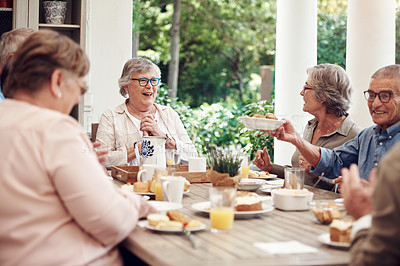 Buy stock photo Cropped shot of a group of senior citizens sitting together and enjoying a tea party outdoors
