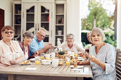 Buy stock photo Cropped portrait of a group of senior citizens sitting together and enjoying a tea party outdoors