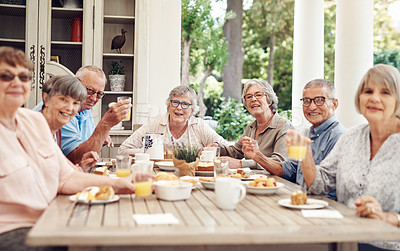 Buy stock photo Cropped portrait of a group of senior citizens sitting together and enjoying a tea party outdoors
