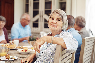 Buy stock photo Cropped portrait of a happy senior woman sitting and enjoying a tea party with her friends outdoors