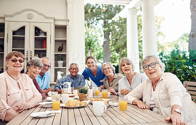 Buy stock photo Cropped portrait of a group of senior citizens sitting together and enjoying a tea party outdoors