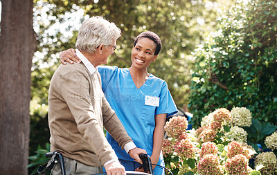 Buy stock photo Cropped shot of an attractive young nurse helping her senior patient walk with his walker during a day outdoors