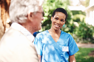 Buy stock photo Cropped shot of an attractive young nurse standing with her senior patient during a day outdoors