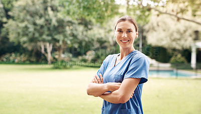 Buy stock photo Portrait of a confident young nurse standing outside in the garden of a retirement home