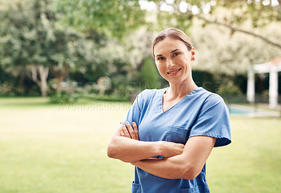 Buy stock photo Portrait of a confident young nurse standing outside in the garden of a retirement home
