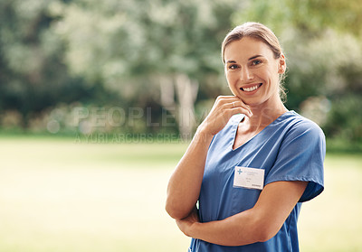 Buy stock photo Portrait of a confident young nurse standing outside in the garden of a retirement home