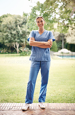 Buy stock photo Portrait of a confident young nurse standing outside in the garden of a retirement home