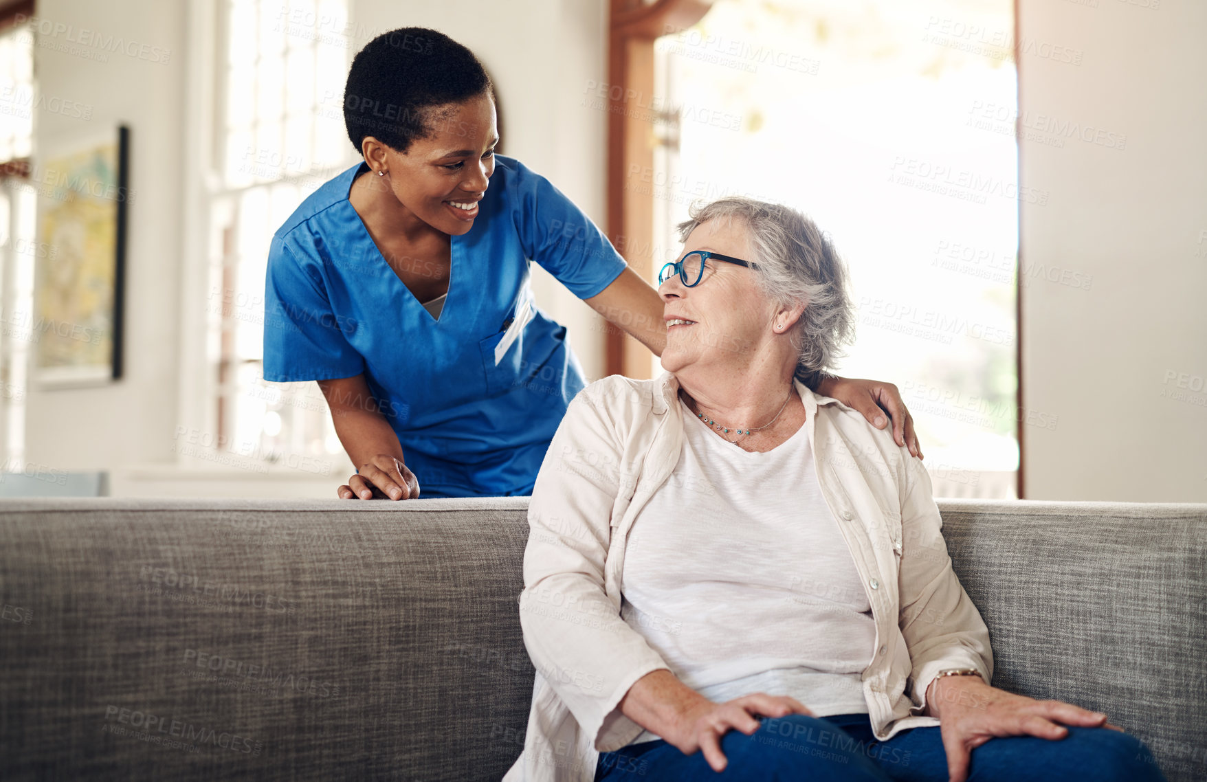 Buy stock photo Shot of a senior woman being cared for by a young nurse at home