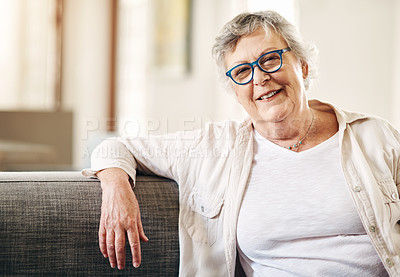 Buy stock photo Shot of a happy senior woman relaxing on the sofa at home