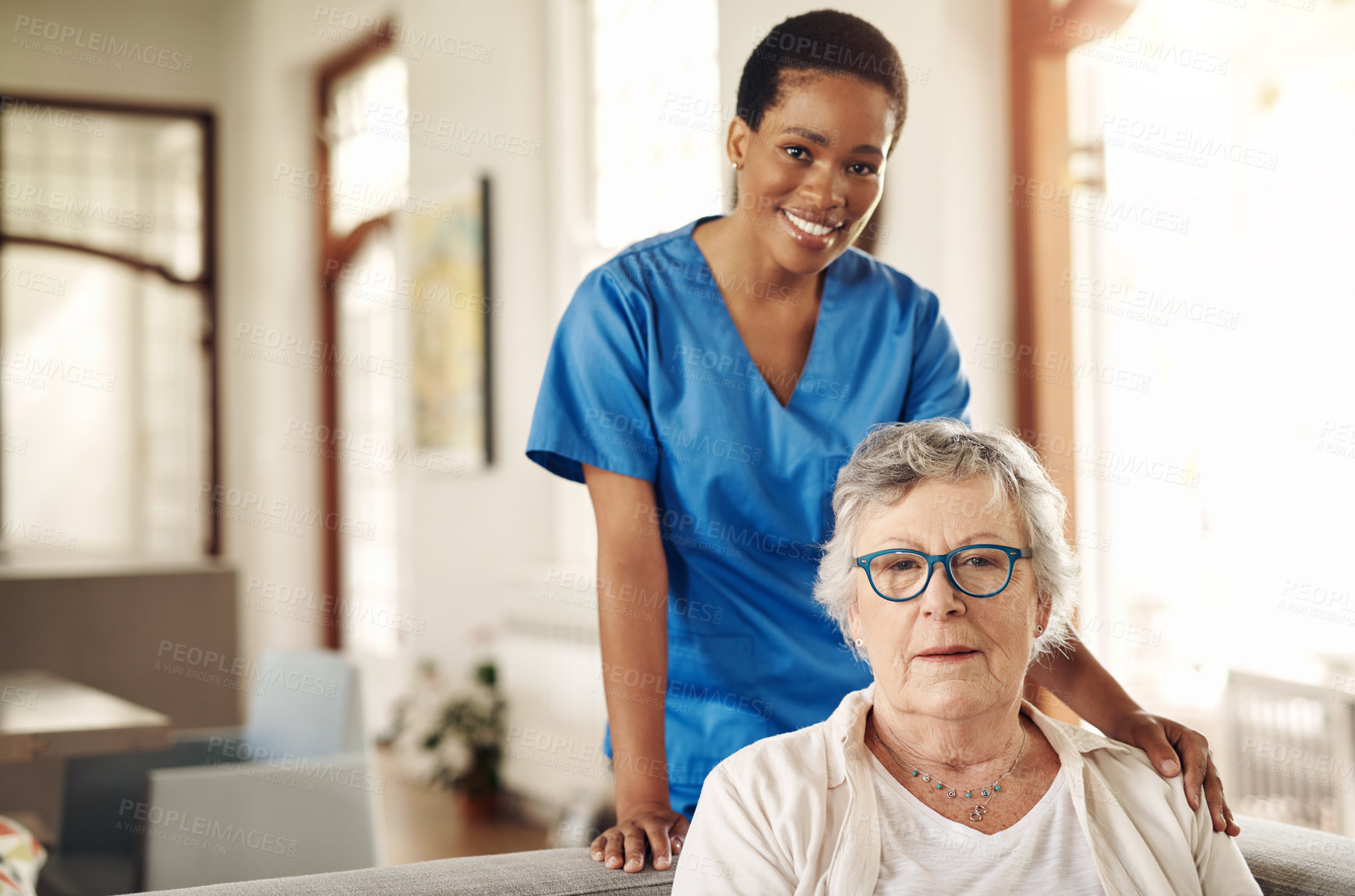 Buy stock photo Shot of a senior woman being cared for by a young nurse at home