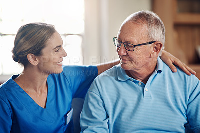Buy stock photo Shot of a senior man being cared for by a young nurse at home