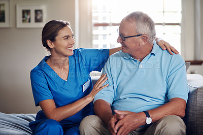 Buy stock photo Shot of a senior man being cared for by a young nurse at home