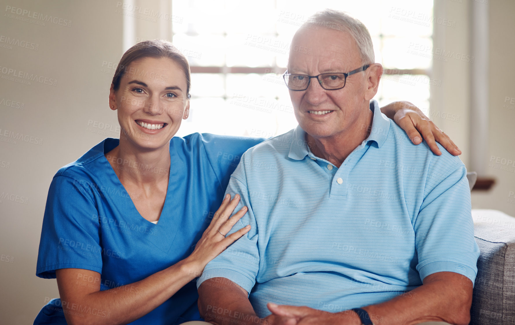 Buy stock photo Shot of a senior man being cared for by a young nurse at home