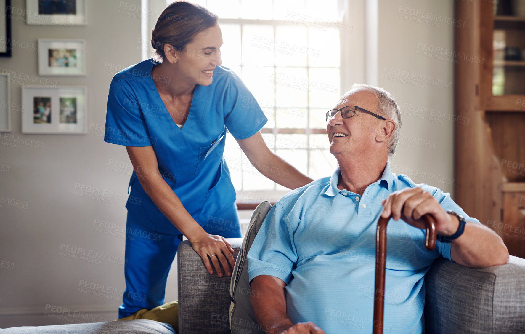 Buy stock photo Shot of a senior man being cared for by a young nurse at home
