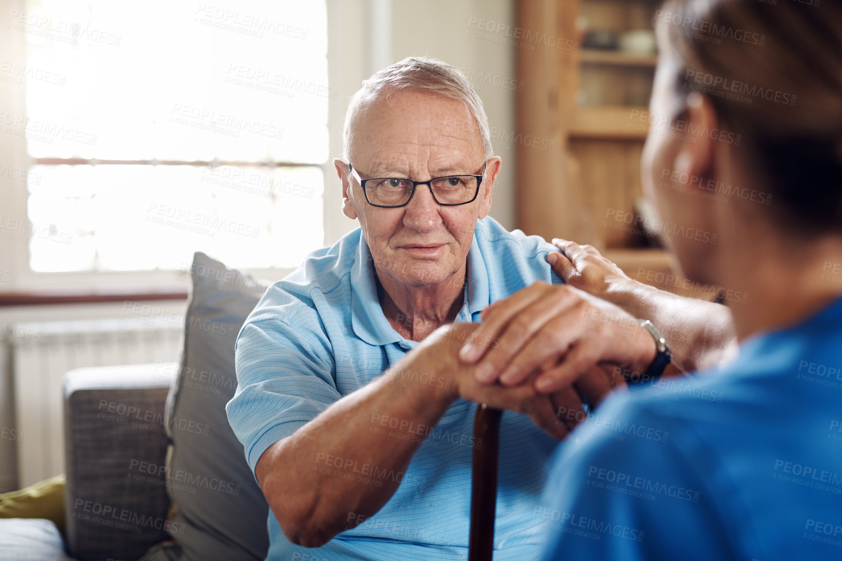 Buy stock photo Shot of a senior man being cared for by a young nurse at home