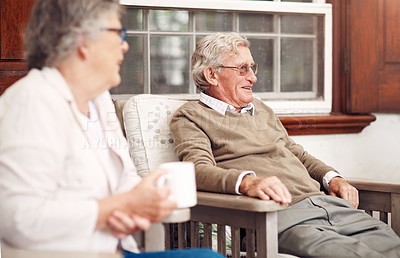 Buy stock photo Cropped shot of a group of senior citizens sitting together and enjoying a day out on the veranda