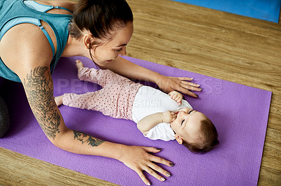 Buy stock photo Cropped shot of an attractive young mother posing with her baby during a baby yoga class indoors
