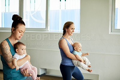 Buy stock photo Cropped shot of a group of mothers holding their babies during a baby yoga class indoors