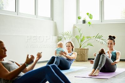 Buy stock photo Cropped shot of a young group of mothers lying down and posing with her babies during a baby yoga class