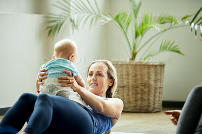 Buy stock photo Cropped shot of an attractive young mother posing with her baby during a baby yoga class indoors