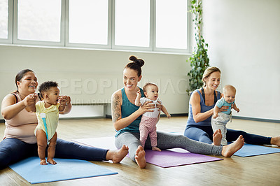 Buy stock photo Cropped shot of a young group of mothers sitting with their babies during a baby yoga class indoors