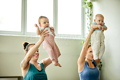 Buy stock photo Cropped shot of two attractive young mothers sitting with their babies during a baby yoga class indoors