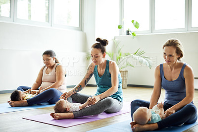 Buy stock photo Full length shot of a young group of mothers sitting with their babies during a baby yoga class indoors