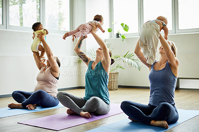 Buy stock photo Full length shot of a young group of mothers sitting with their babies during a baby yoga class indoors
