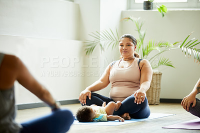 Buy stock photo Cropped shot of an attractive young mother posing with her baby during a baby yoga class indoors