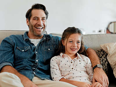 Buy stock photo Shot of a man and his daughter sitting together on the couch at home