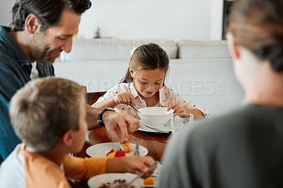 Buy stock photo Shot of a family of four having breakfast together at home