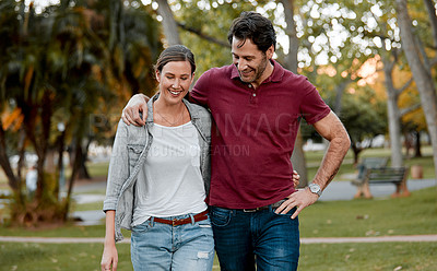 Buy stock photo Cropped shot of an affectionate couple taking a walk through the park