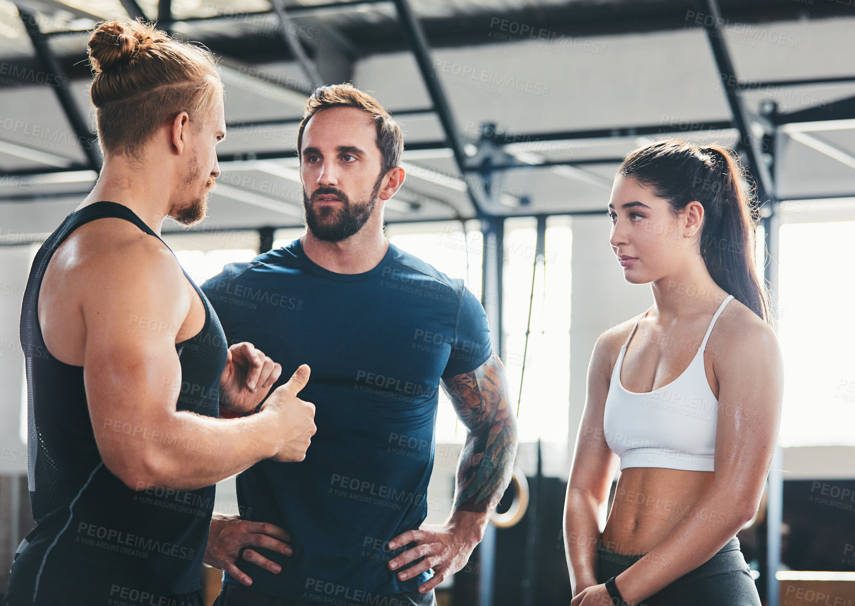 Buy stock photo Cropped shot of a group of young athletes talking while standing in the gym