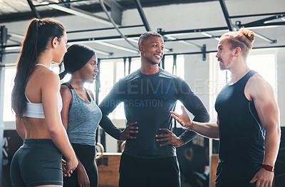 Buy stock photo Cropped shot of a group of young athletes talking while standing in the gym