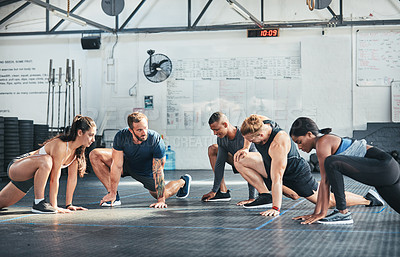 Buy stock photo Cropped shot of a group of young athletes going through their warmup routine in the gym