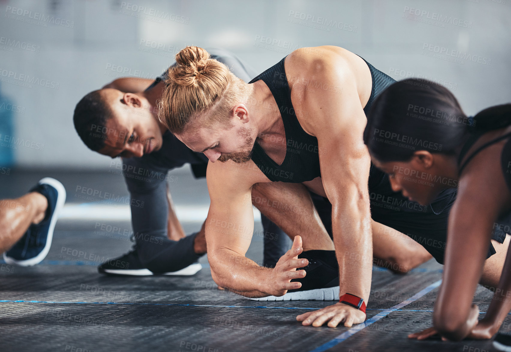Buy stock photo Cropped shot of a group of young athletes going through their warmup routine in the gym