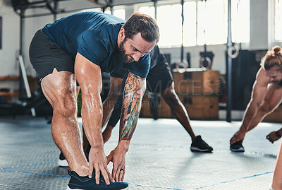 Buy stock photo Cropped shot of a group of young athletes going through their warmup routine in the gym