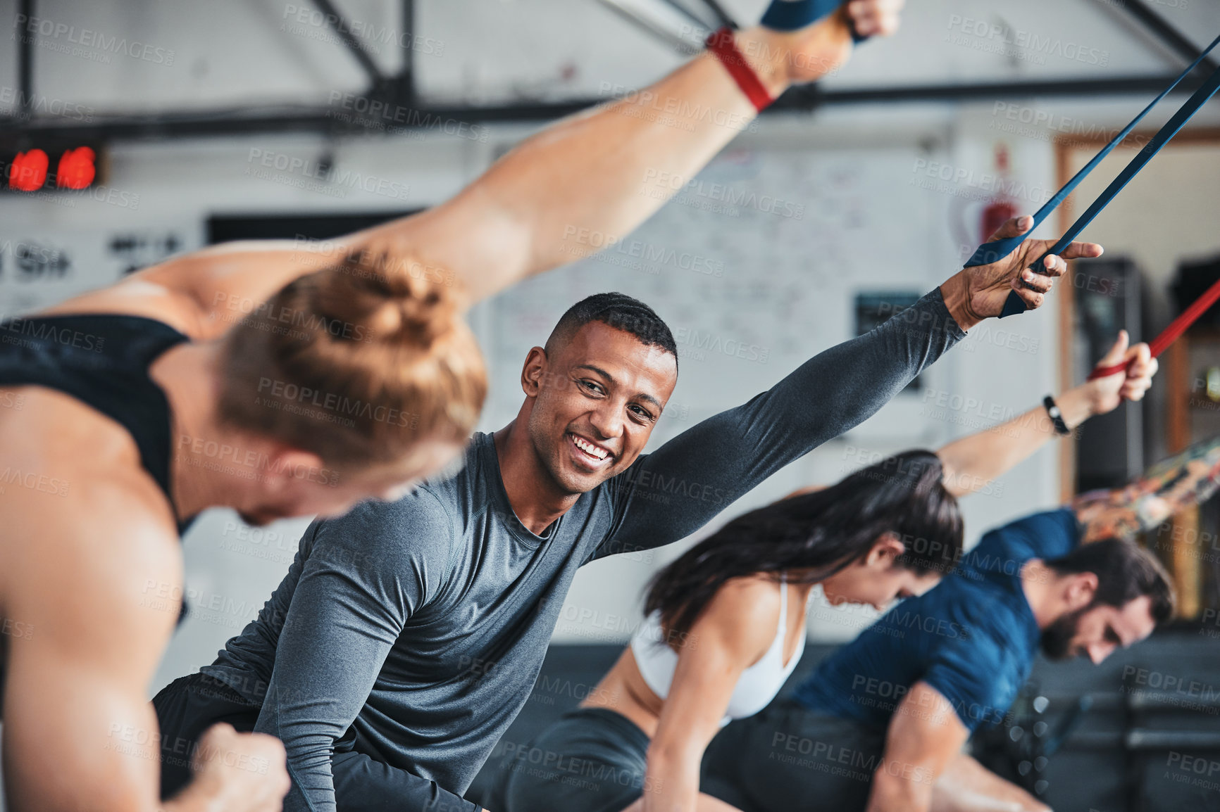 Buy stock photo Cropped shot of a group of young athletes in an exercise class at the gym