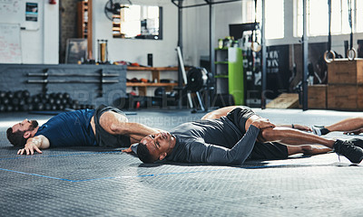 Buy stock photo Cropped shot of a group of young athletes going through their warmup routine in the gym