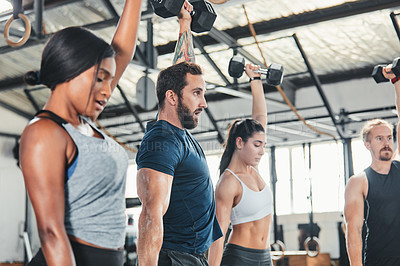 Buy stock photo Cropped shot of a group of young athletes in an exercise class at the gym