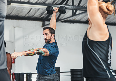 Buy stock photo Cropped shot of a group of young athletes in an exercise class at the gym