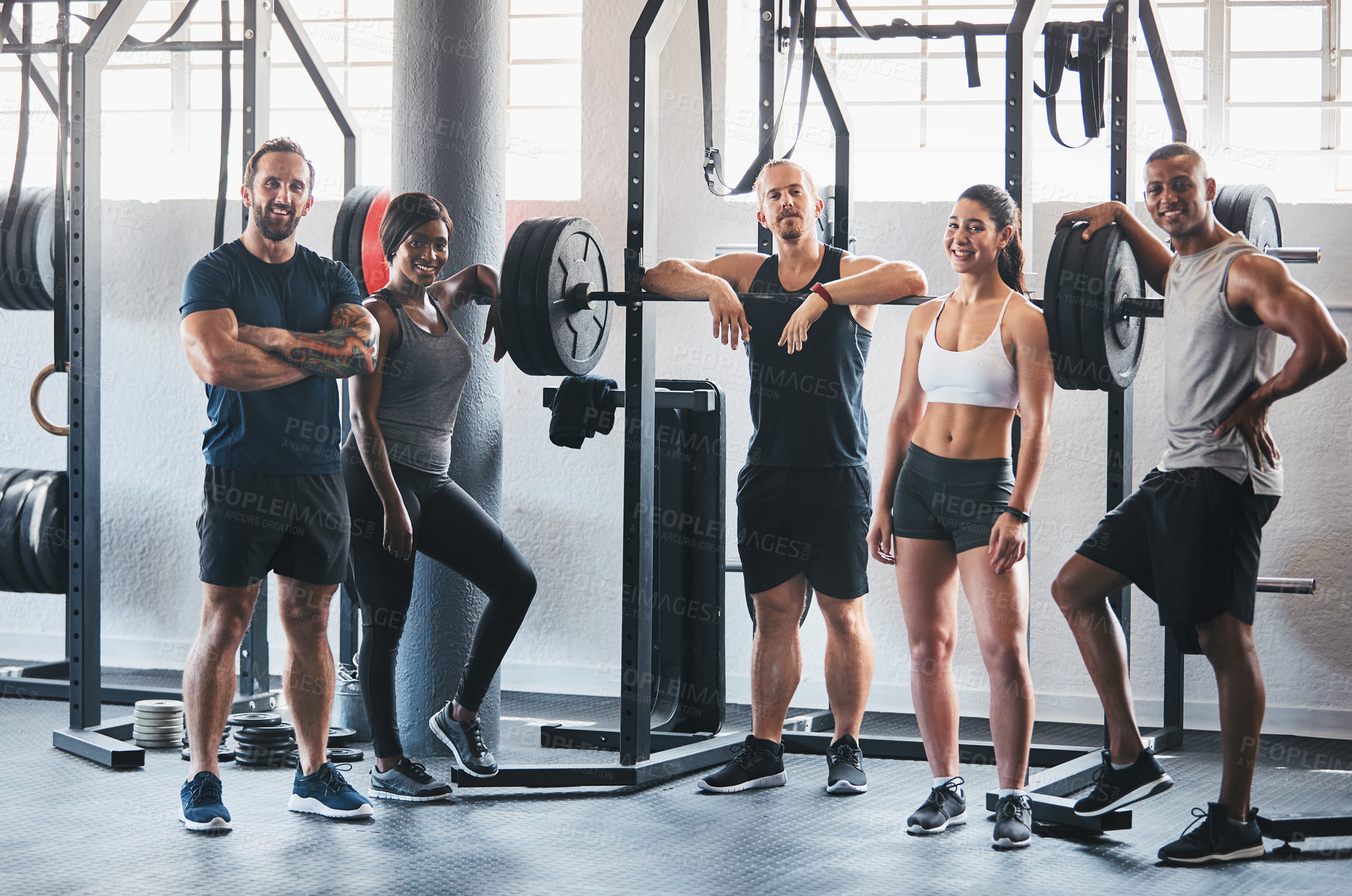 Buy stock photo Portrait of a group of young athletes standing together in the gym