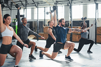 Buy stock photo Shot of a group of young athletes in an exercise class at the gym