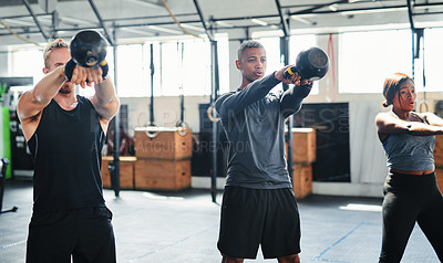 Buy stock photo Shot of a group of young athletes in an exercise class at the gym