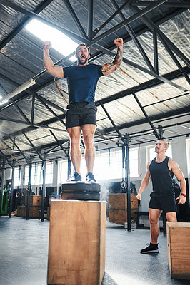 Buy stock photo Shot of a man doing box jumps at the gym