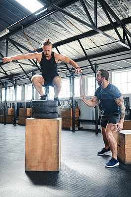 Buy stock photo Shot of a man doing box jumps at the gym