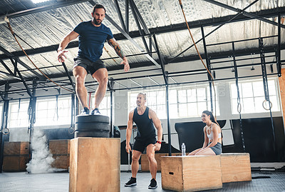 Buy stock photo Shot of a man doing box jumps at the gym