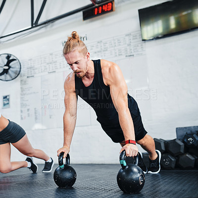 Buy stock photo Shot of an athletic young man working out at the gym