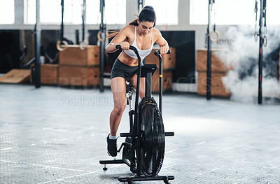 Buy stock photo Shot of a young woman doing cardio at the gym