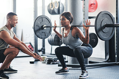 Buy stock photo Shot of a young woman working out with a barbell at the gym